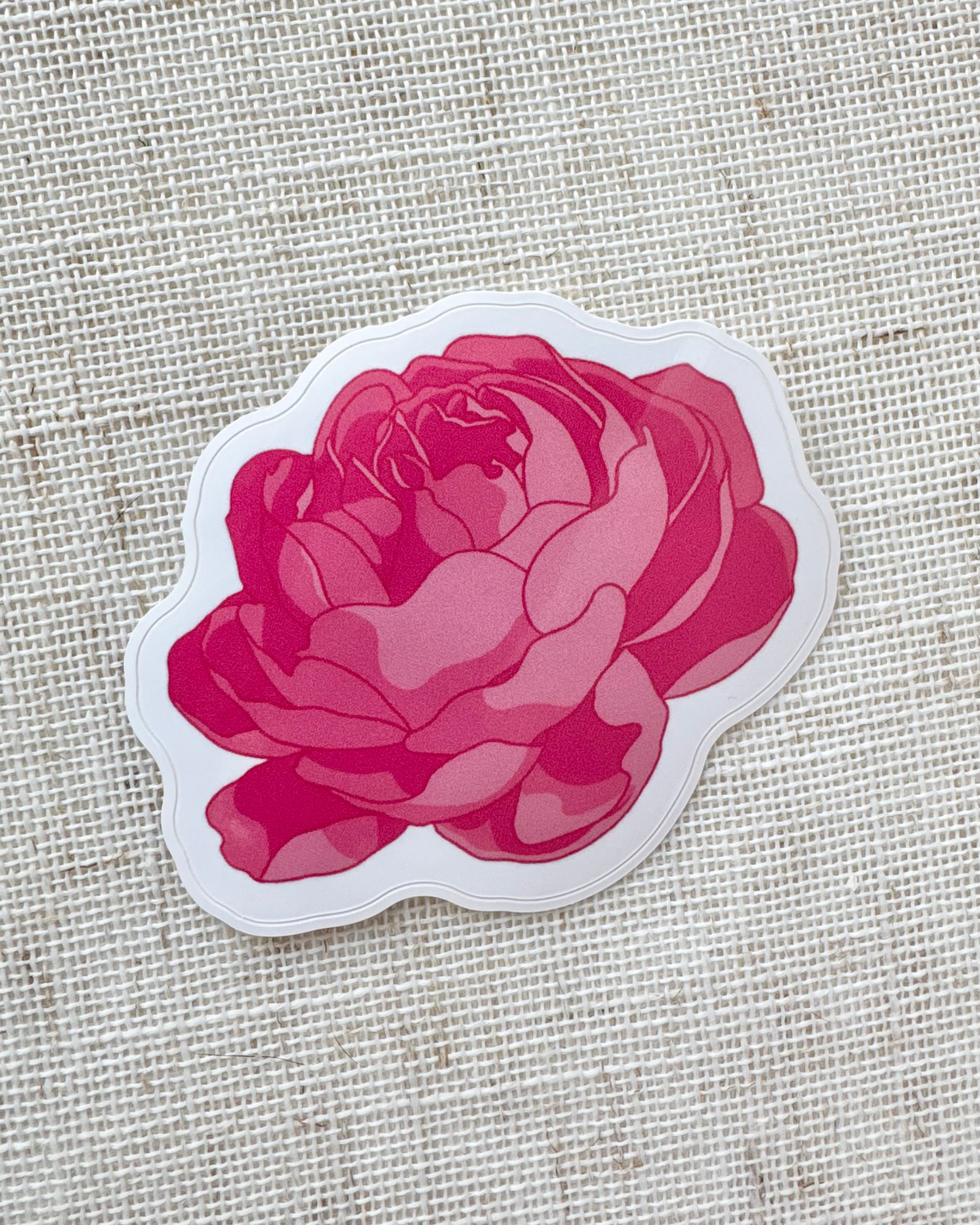 Sticker of a dark pink peony on a textured beige background
