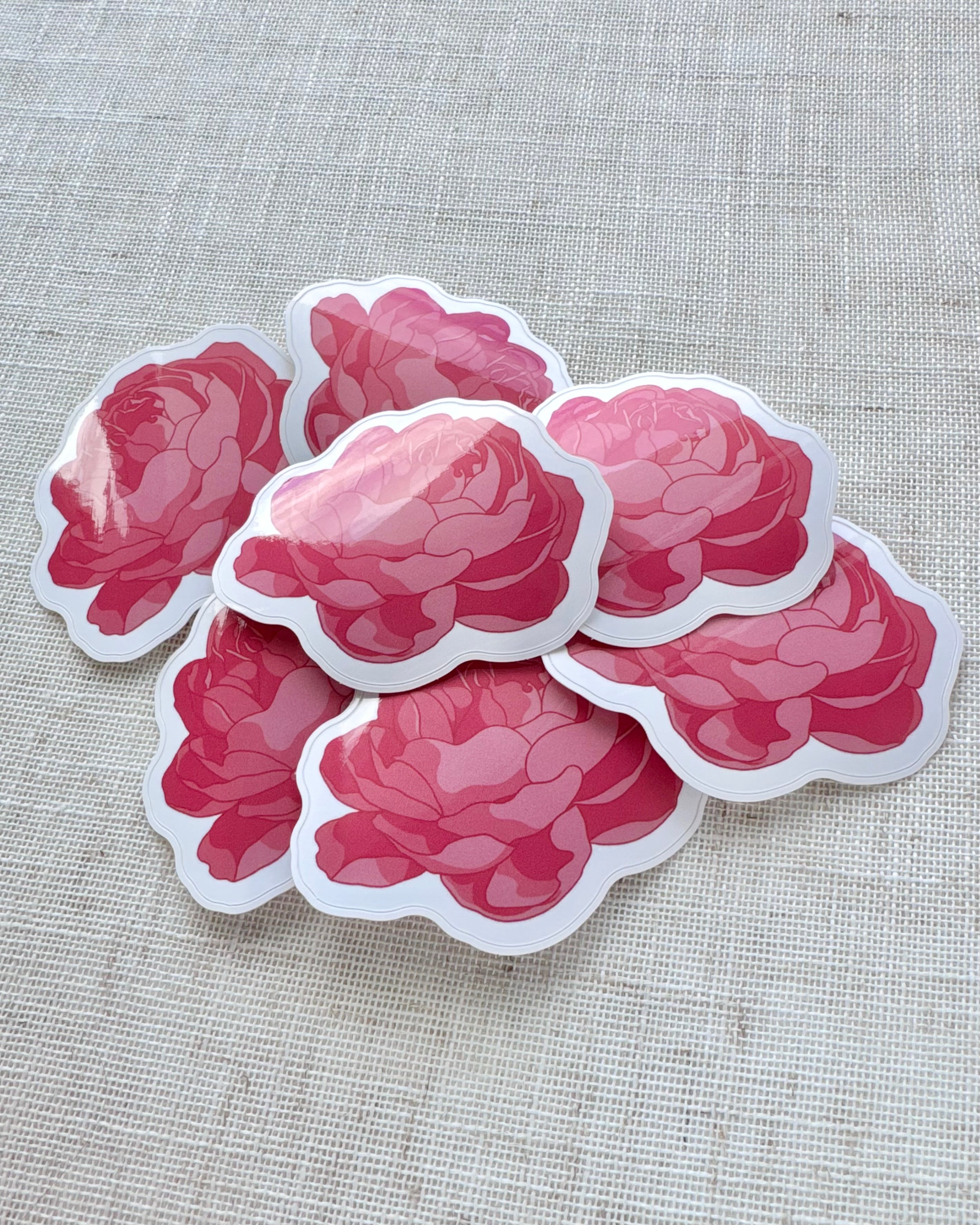 Set of pink peony flower stickers on a textured beige background
